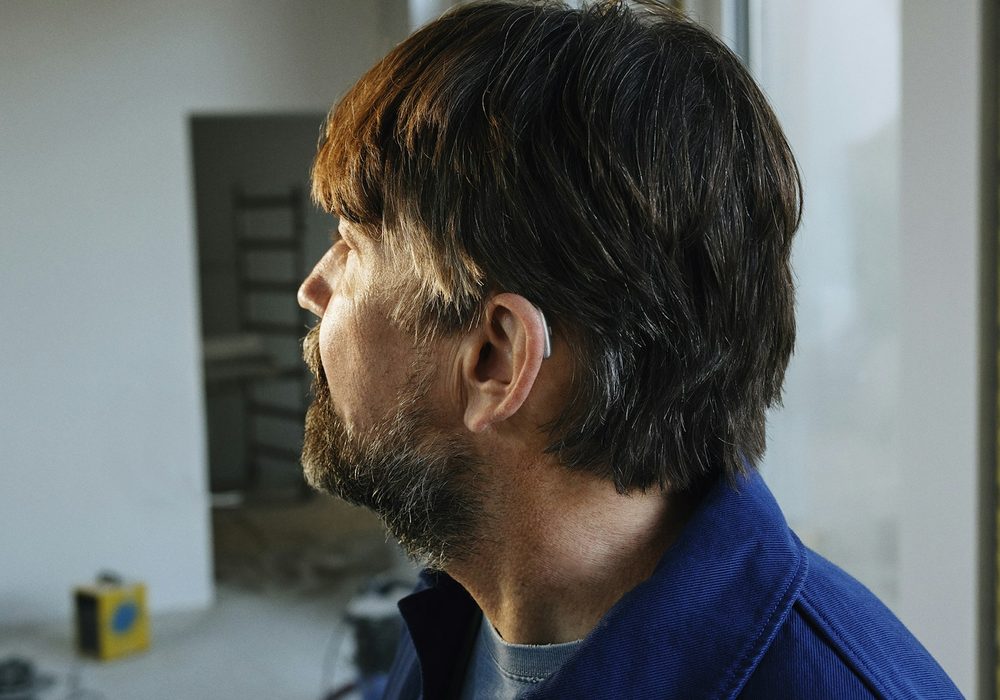Construction lead in work clothing standing in an unfinished interior