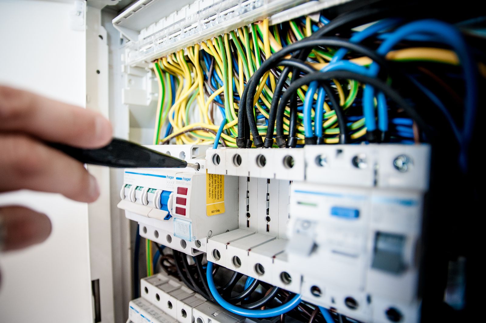Close-up of terminal blocks and colour-coded wiring inside a distribution panel