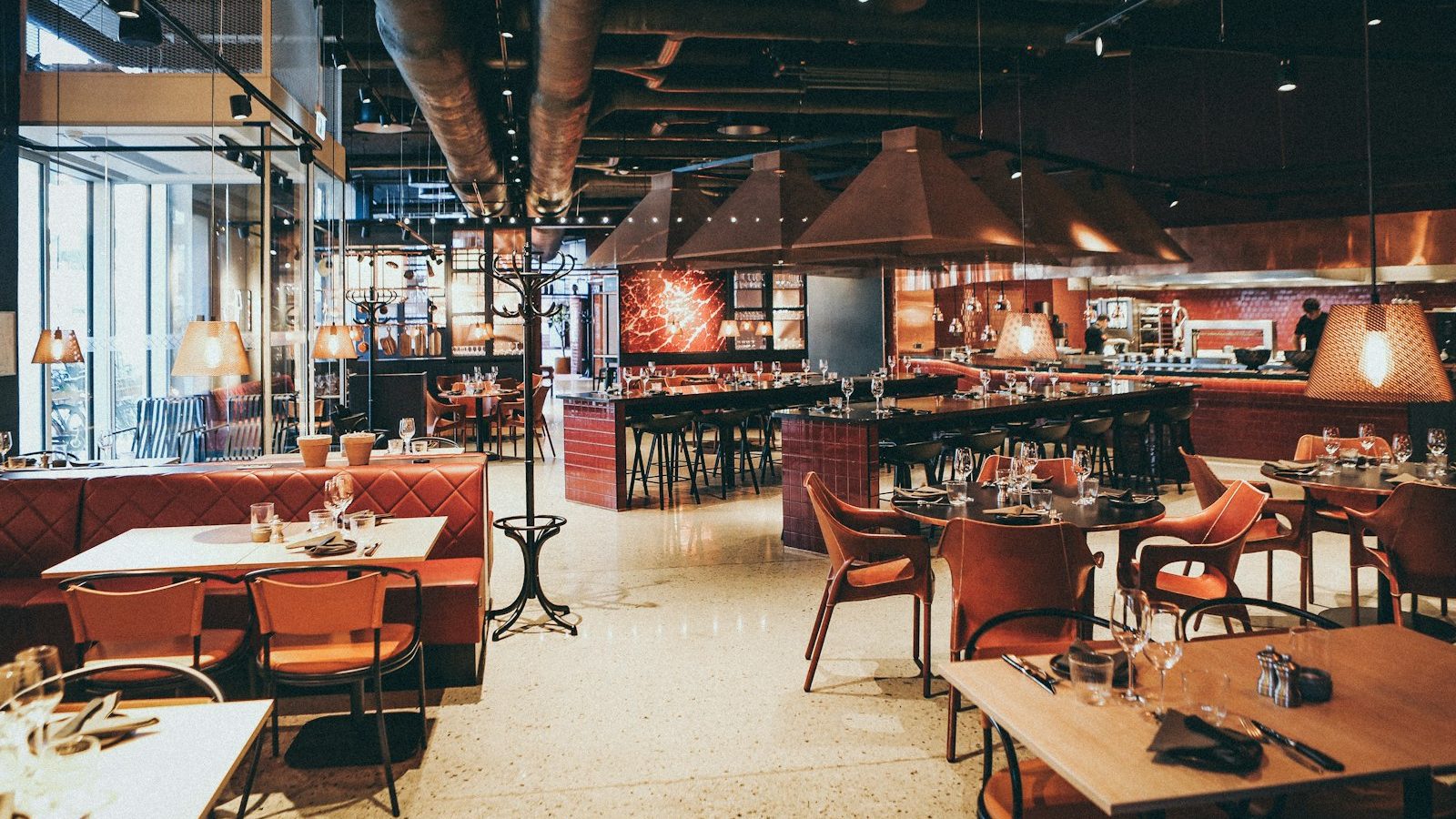 Restaurant dining room with warm pendant lighting and booth seating